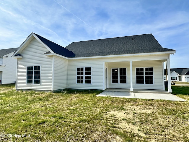 rear view of house featuring a patio and a lawn