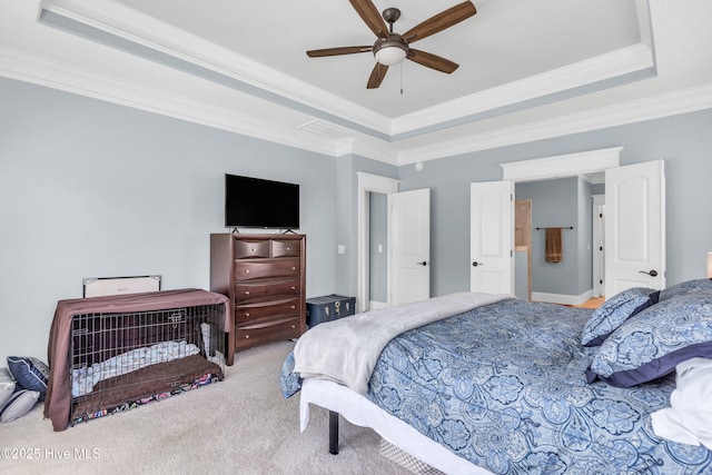 bedroom with carpet flooring, a ceiling fan, a tray ceiling, and ornamental molding