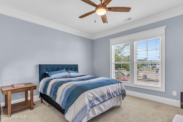 bedroom featuring visible vents, ornamental molding, baseboards, light colored carpet, and a ceiling fan