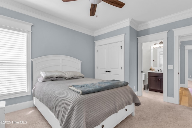 bedroom featuring baseboards, light carpet, ornamental molding, and a closet