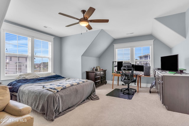 bedroom featuring ceiling fan, light colored carpet, baseboards, lofted ceiling, and visible vents