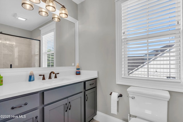 full bathroom with vanity, baseboards, walk in shower, and toilet