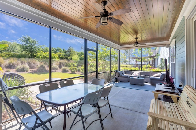 sunroom featuring an outdoor living space, a ceiling fan, and outdoor dining space