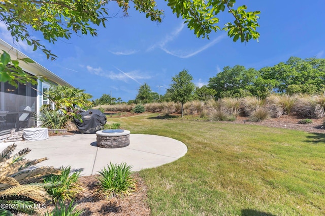 view of yard featuring a patio area and an outdoor fire pit
