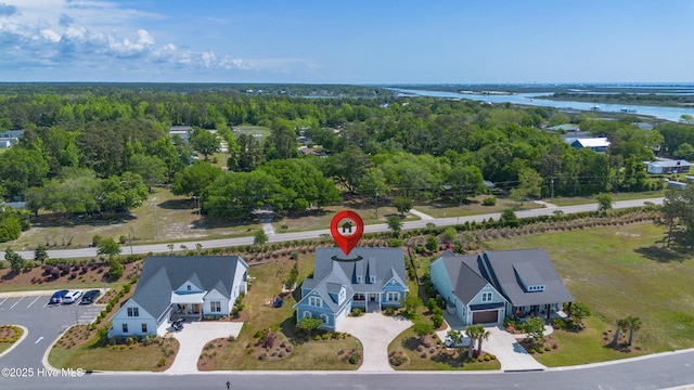 drone / aerial view featuring a water view and a view of trees