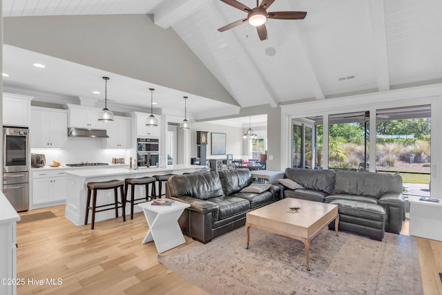 living area featuring a ceiling fan, beam ceiling, high vaulted ceiling, recessed lighting, and light wood-style flooring