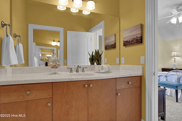 bathroom featuring connected bathroom, vanity, and a ceiling fan