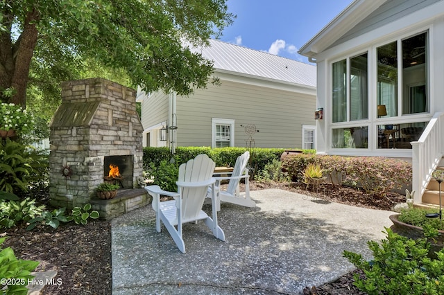 view of patio / terrace with an outdoor stone fireplace