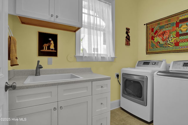 laundry room with washing machine and clothes dryer, cabinet space, and light tile patterned floors