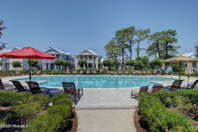 community pool with fence and a patio