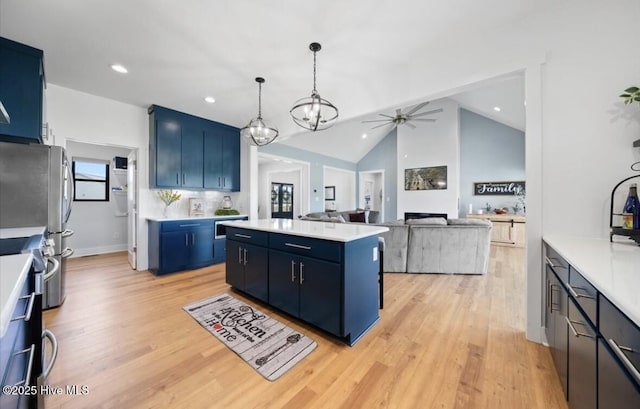 kitchen with a kitchen island, a ceiling fan, and light countertops