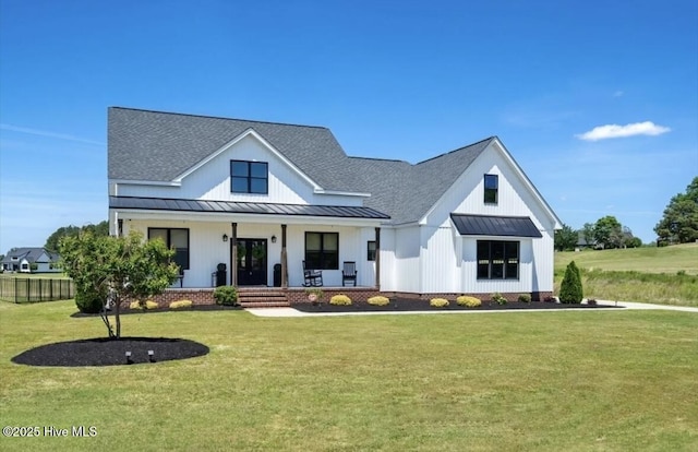 view of front of property featuring a shingled roof, metal roof, and a standing seam roof