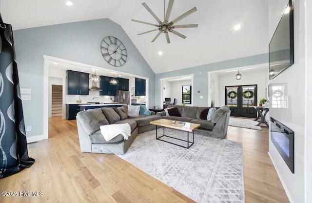 living area with a ceiling fan, high vaulted ceiling, recessed lighting, and light wood finished floors