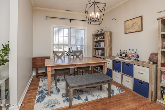 office featuring crown molding, a chandelier, visible vents, and light wood-style flooring