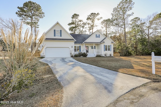 view of front of house featuring a porch, driveway, a front yard, and a garage