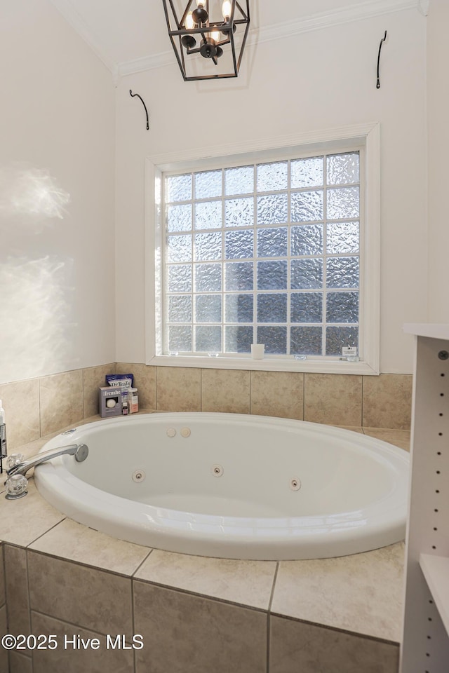 full bathroom with plenty of natural light, ornamental molding, and a jetted tub