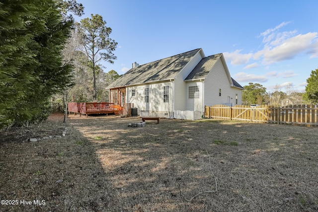 rear view of house featuring fence, a gate, and a deck