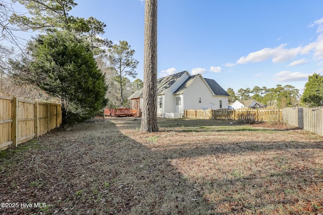 view of yard featuring a fenced backyard and a deck