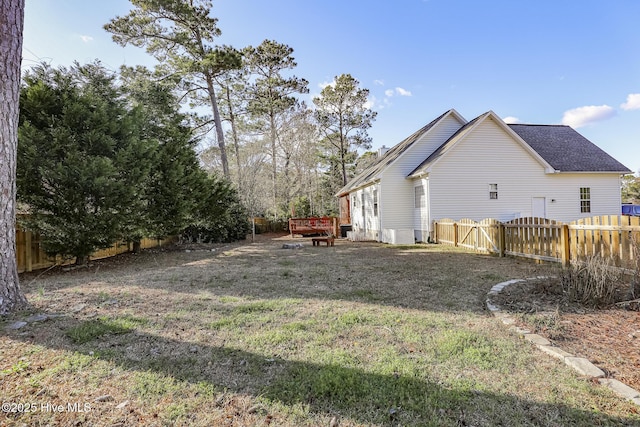 view of yard with a wooden deck and a fenced backyard