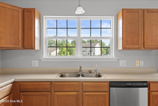 kitchen featuring a sink, dishwasher, decorative light fixtures, and light countertops