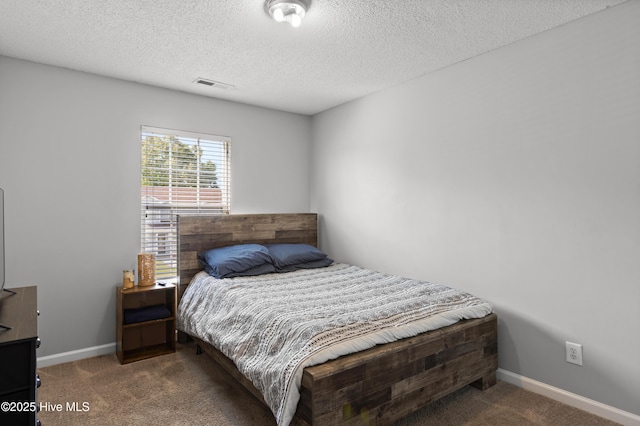 bedroom featuring carpet floors, baseboards, a textured ceiling, and visible vents
