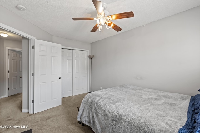 carpeted bedroom with a ceiling fan, a textured ceiling, baseboards, and a closet