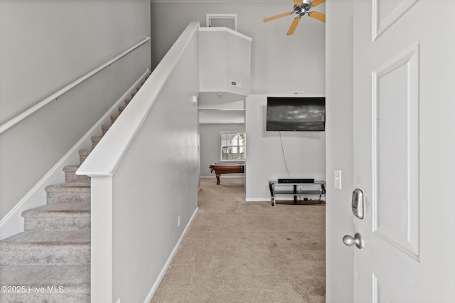staircase featuring billiards, a ceiling fan, visible vents, baseboards, and carpet flooring