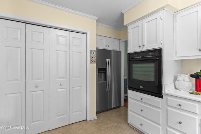 703 Baby Doe Cir, Hampstead, NC 28443 - kitchen with ornamental molding, oven, light countertops, white cabinetry, and stainless steel fridge with ice dispenser