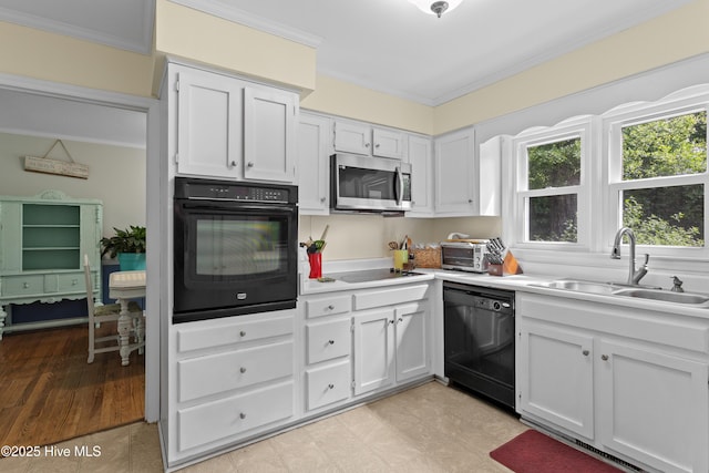 703 Baby Doe Cir, Hampstead, NC 28443 - kitchen featuring a sink, ornamental molding, black appliances, and white cabinetry