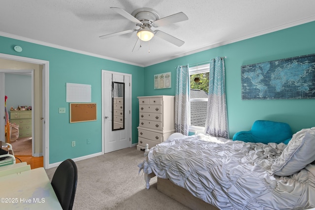 703 Baby Doe Cir, Hampstead, NC 28443 - bedroom featuring ceiling fan, a textured ceiling, crown molding, baseboards, and carpet