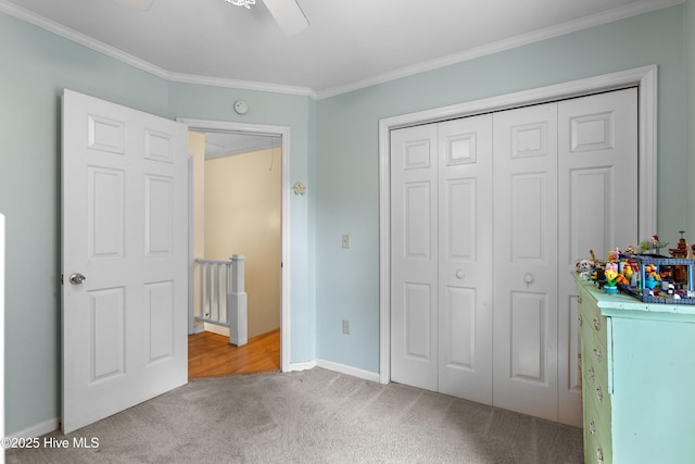703 Baby Doe Cir, Hampstead, NC 28443 - unfurnished bedroom with crown molding, carpet, a ceiling fan, baseboards, and a closet