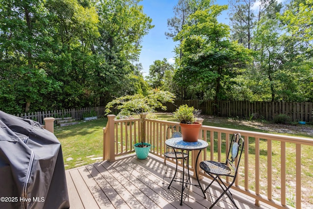703 Baby Doe Cir, Hampstead, NC 28443 - wooden terrace with a lawn, a fenced backyard, and area for grilling