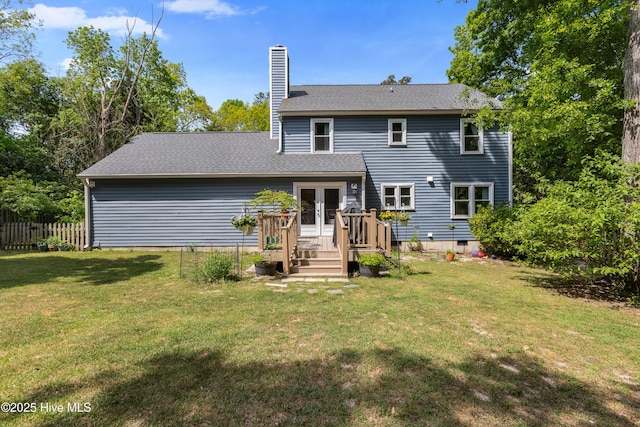 703 Baby Doe Cir, Hampstead, NC 28443 - back of house with fence, a shingled roof, a chimney, french doors, and a yard