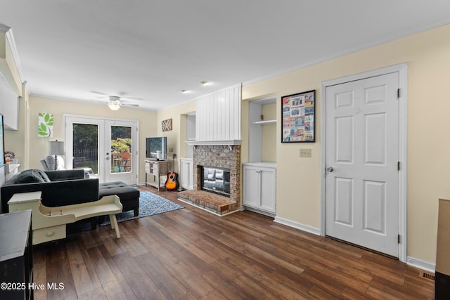 703 Baby Doe Cir, Hampstead, NC 28443 - living area with crown molding, ceiling fan, a fireplace, baseboards, and dark wood-type flooring