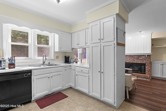 703 Baby Doe Cir, Hampstead, NC 28443 - kitchen featuring crown molding, a sink, dishwasher, light countertops, and white cabinetry