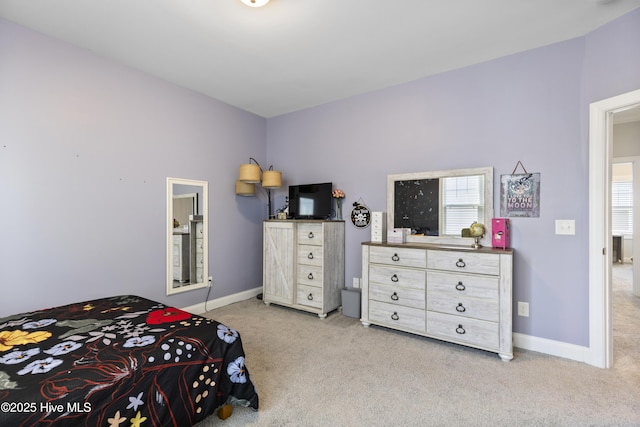 bedroom featuring baseboards and carpet