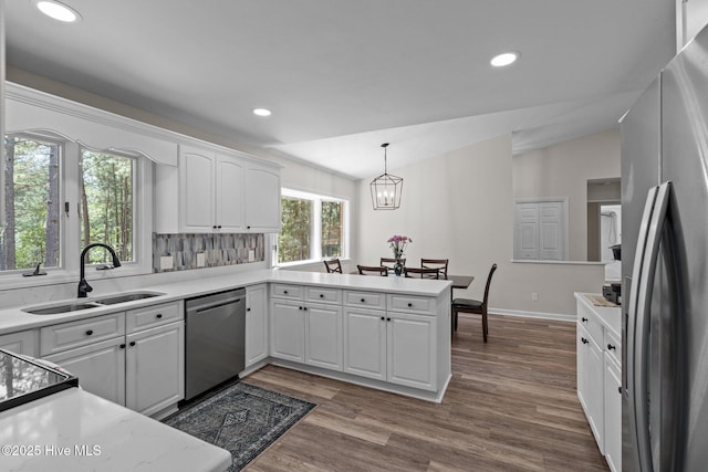180 Lancashire Ln, West End, NC 27376 - kitchen featuring white cabinets, appliances with stainless steel finishes, a sink, recessed lighting, and vaulted ceiling