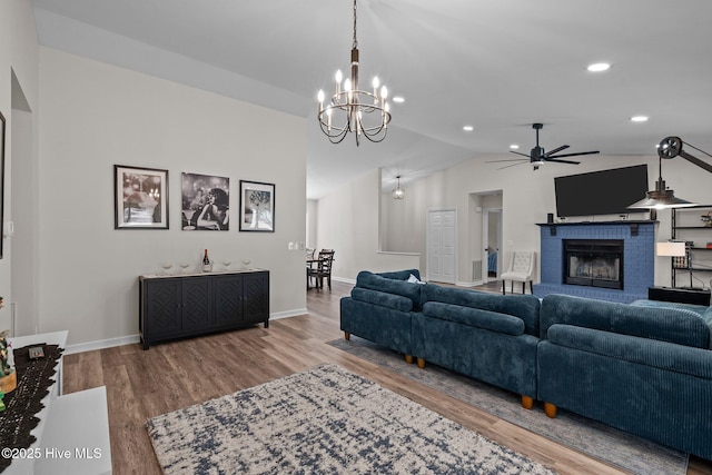 180 Lancashire Ln, West End, NC 27376 - living area with a fireplace, wood finished floors, baseboards, ceiling fan with notable chandelier, and lofted ceiling