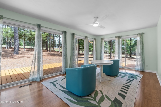 180 Lancashire Ln, West End, NC 27376 - unfurnished sunroom featuring baseboards, wood finished floors, and visible vents