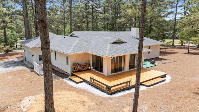 180 Lancashire Ln, West End, NC 27376 - rear view of property with roof with shingles, a garage, a wooden deck, a chimney, and concrete driveway