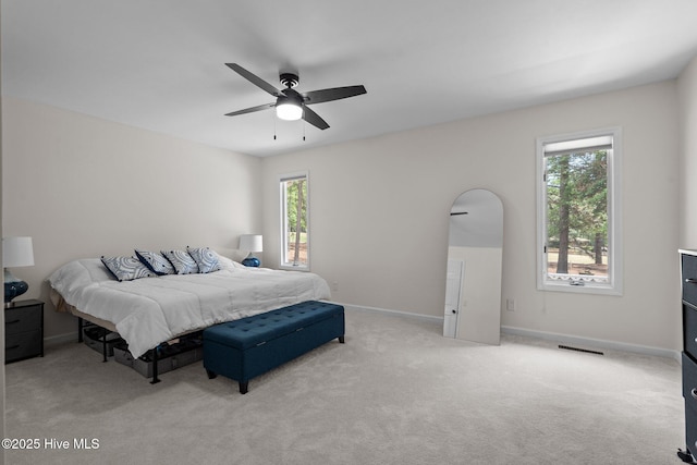 180 Lancashire Ln, West End, NC 27376 - bedroom featuring visible vents, baseboards, multiple windows, and light colored carpet