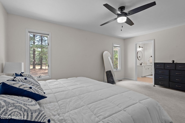180 Lancashire Ln, West End, NC 27376 - bedroom with light colored carpet, a ceiling fan, baseboards, and ensuite bathroom