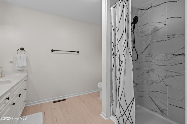 180 Lancashire Ln, West End, NC 27376 - bathroom featuring visible vents, a stall shower, wood finished floors, vanity, and toilet