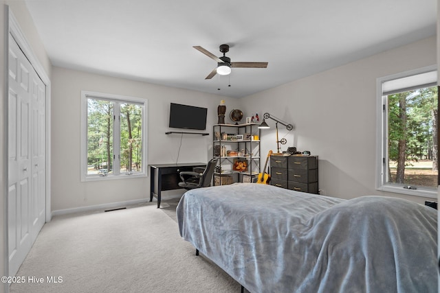 180 Lancashire Ln, West End, NC 27376 - carpeted bedroom with baseboards, a ceiling fan, and a closet