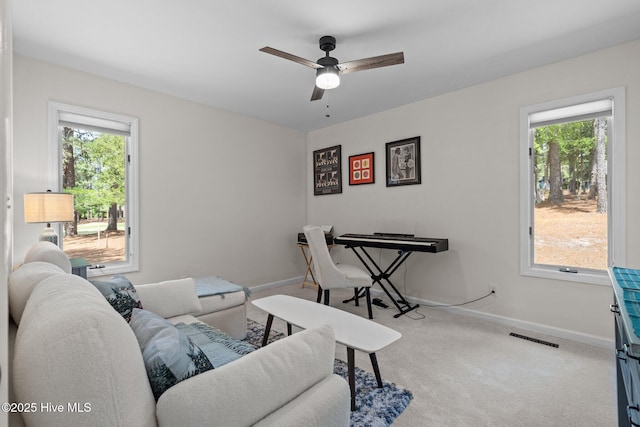 180 Lancashire Ln, West End, NC 27376 - living room featuring carpet floors, a ceiling fan, visible vents, and a wealth of natural light