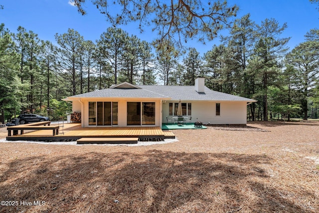 180 Lancashire Ln, West End, NC 27376 - back of property featuring a shingled roof, a wooden deck, and a chimney