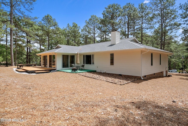 180 Lancashire Ln, West End, NC 27376 - rear view of house featuring a shingled roof, a wooden deck, a chimney, and crawl space