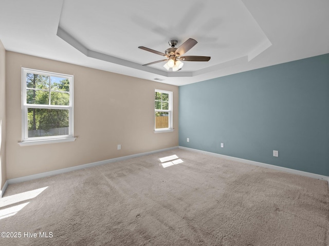 212 Peaceful Ln, Hubert, NC 28539 - spare room featuring visible vents, carpet flooring, baseboards, a raised ceiling, and a ceiling fan