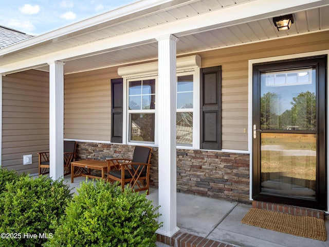212 Peaceful Ln, Hubert, NC 28539 - view of exterior entry featuring covered porch and stone siding