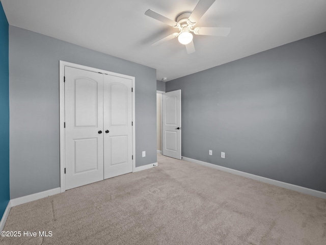 212 Peaceful Ln, Hubert, NC 28539 - unfurnished bedroom featuring carpet floors, baseboards, a ceiling fan, and a closet